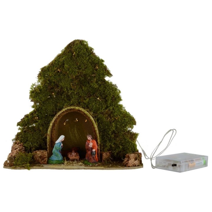 Tree with hut and Nativity illuminated with piled with