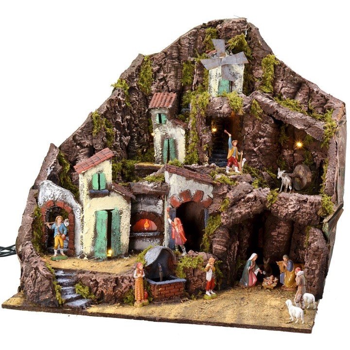 Illuminated nativity scene complete with Landi statues with fountain, fire