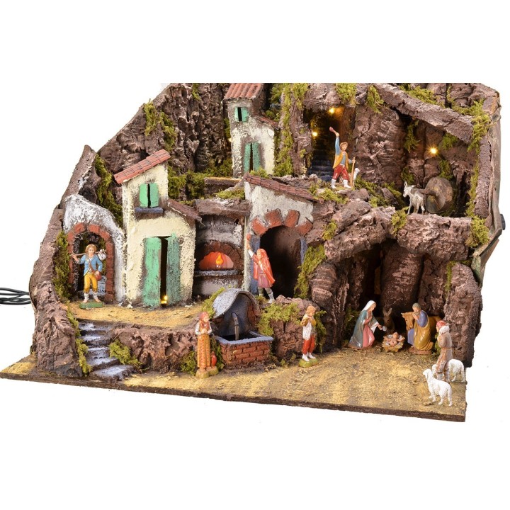 Illuminated nativity scene complete with Landi statues with fountain, fire