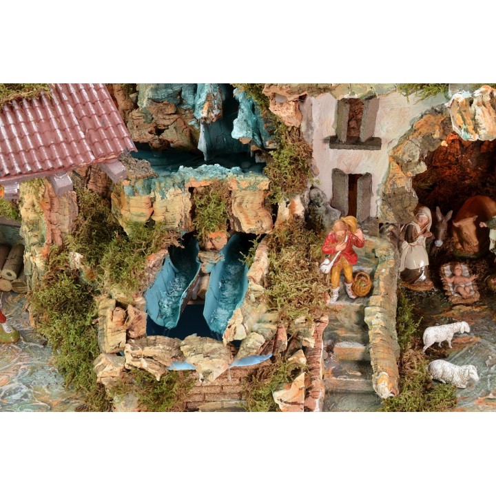 Illuminated nativity scene complete with Landi statues and double waterfall