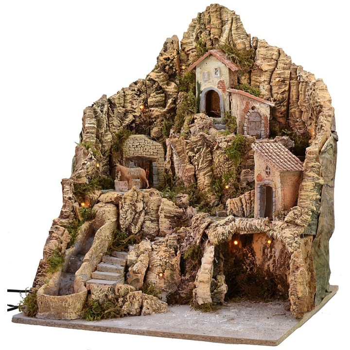 Illuminated nativity scene with working waterfall and donkey at the millstone