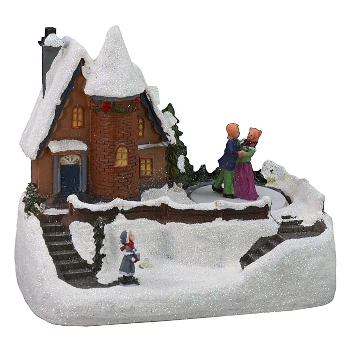 Snowy house scenario with battery-operated skating rink