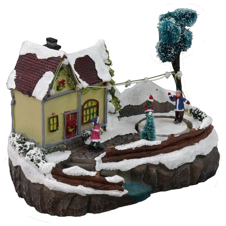 Escenario navideño con casa y pista de patinaje funcionando con