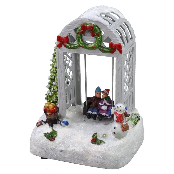 Escenario navideño niños en el columpio funcionando a pilas de