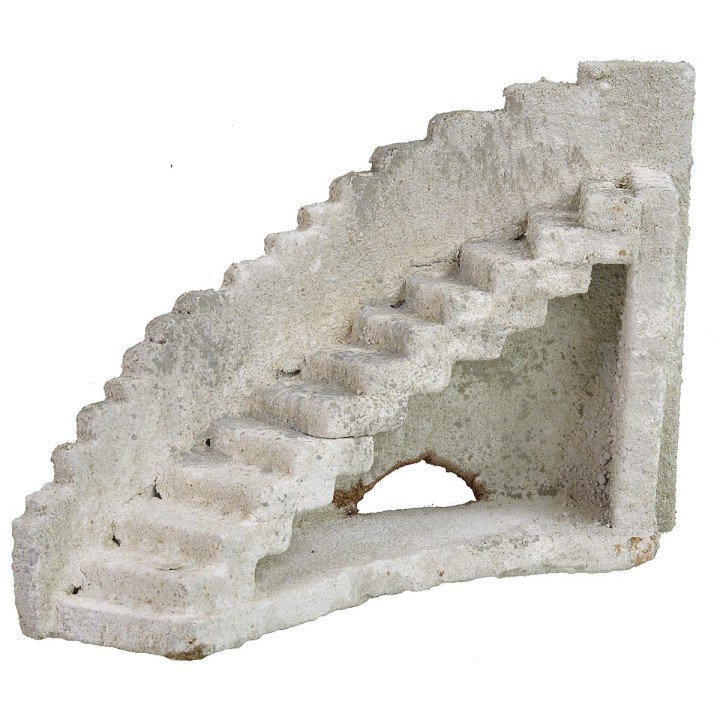 Facade of an ancient castle with curved staircase to the right