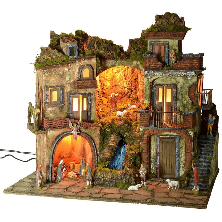 Illuminated 18th-century-style nativity scene with waterfall, complete with statues