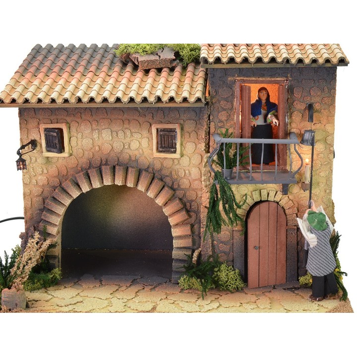Casa illuminata con lampionaio 12 cm in movimento e donna che