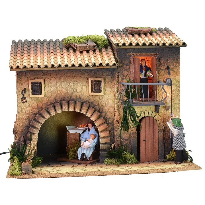 Casa iluminada con farolero de 12 cm en movimiento y mujer que