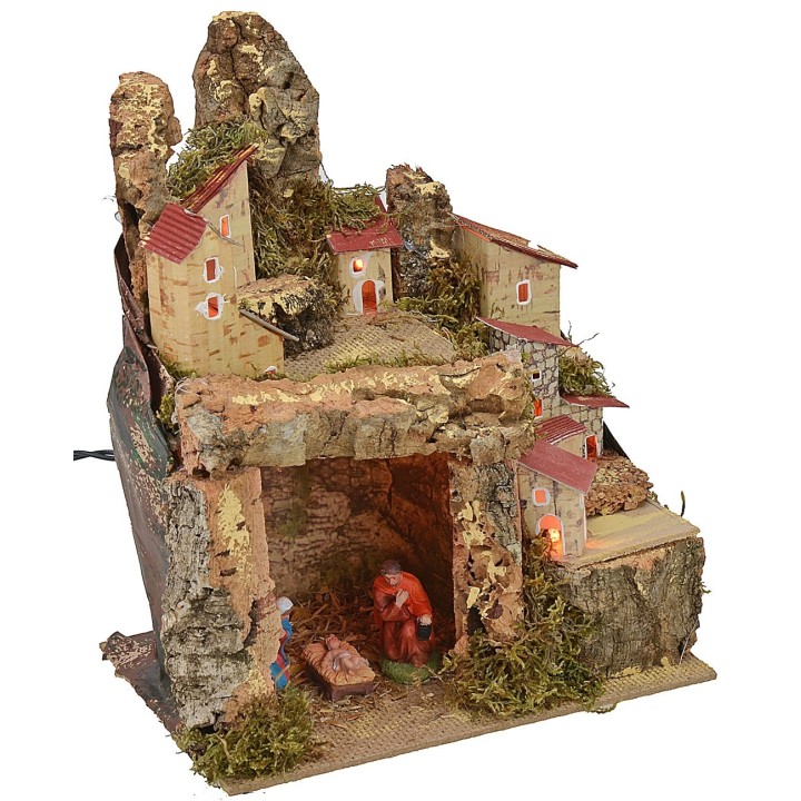 Illuminated nativity scene with landscape and cave complete with Nativity