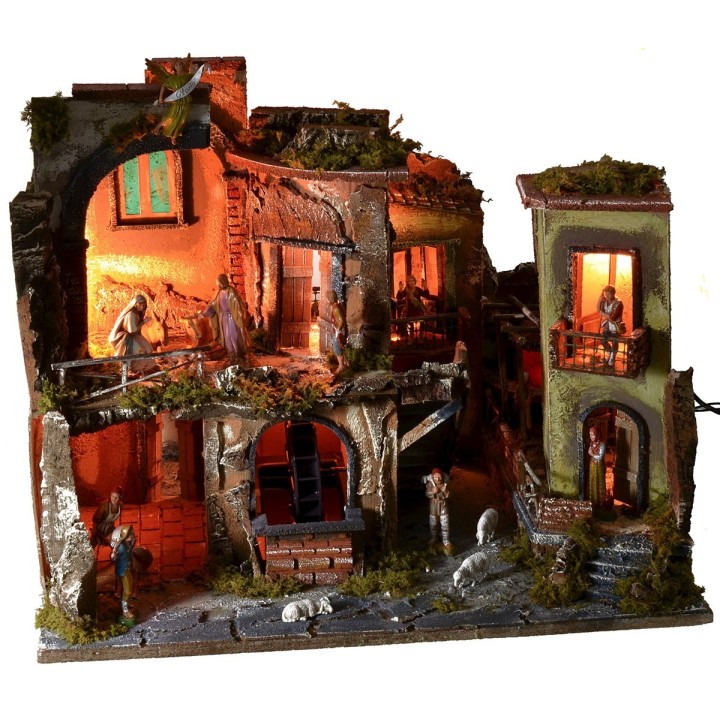 Complete nativity scene with statues, illuminated village, and oven