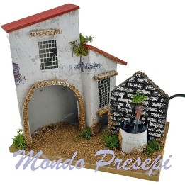Casa con fuente para belén de 21x13x18 cm de altura.