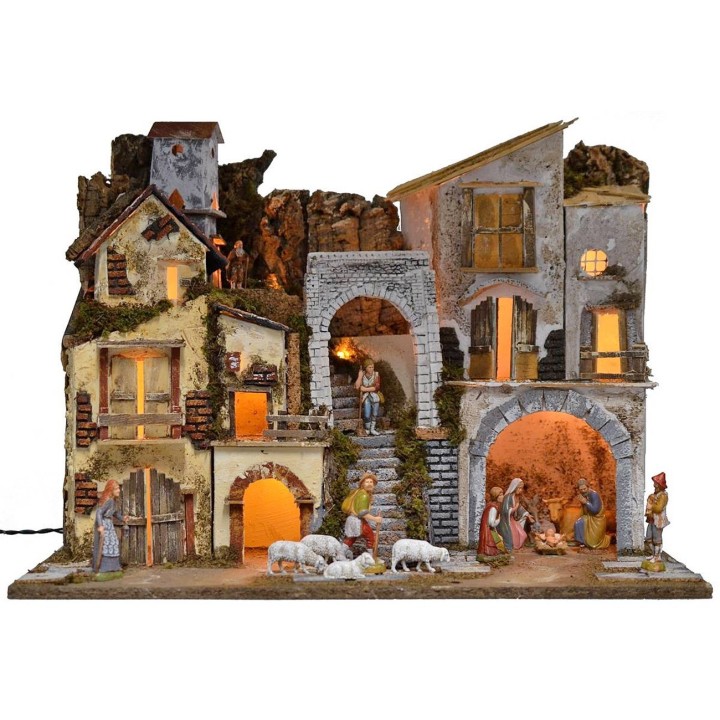 Illuminated nativity scene complete with Landi statues with village and cave