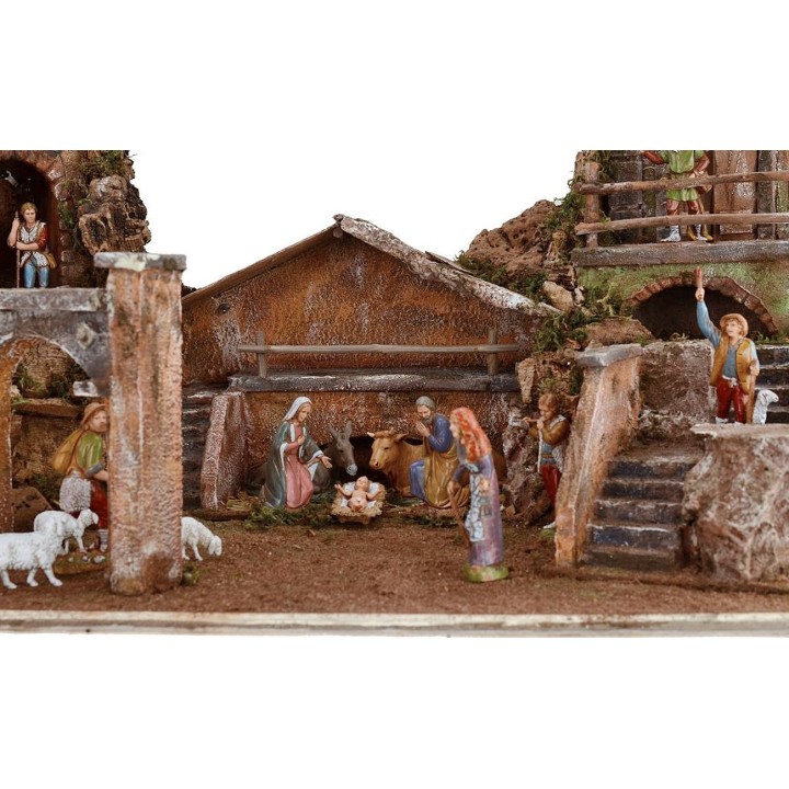 Illuminated nativity scene complete with Landi statues with houses and fountain