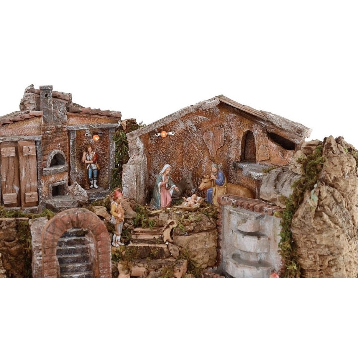 Illuminated nativity scene complete with Landi statues and landscape