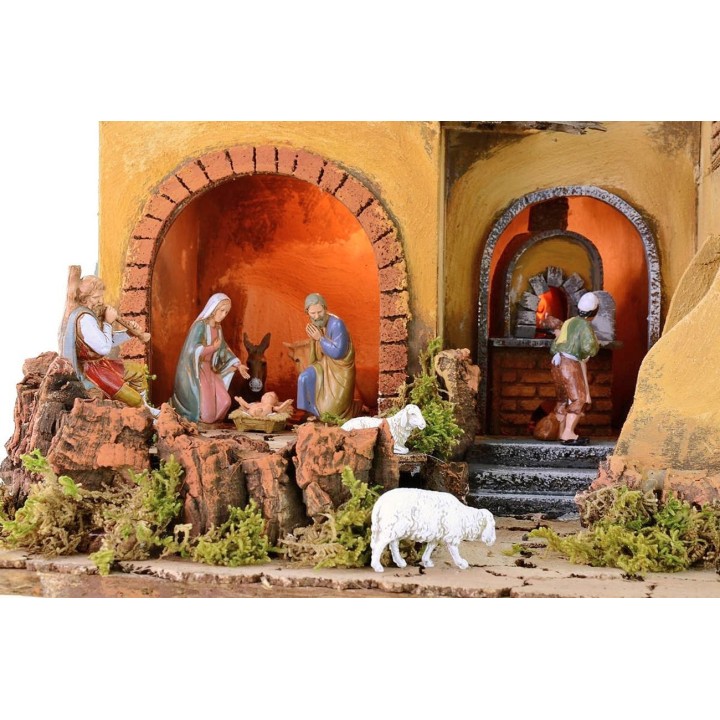 Illuminated nativity scene complete with Landi statues and fire