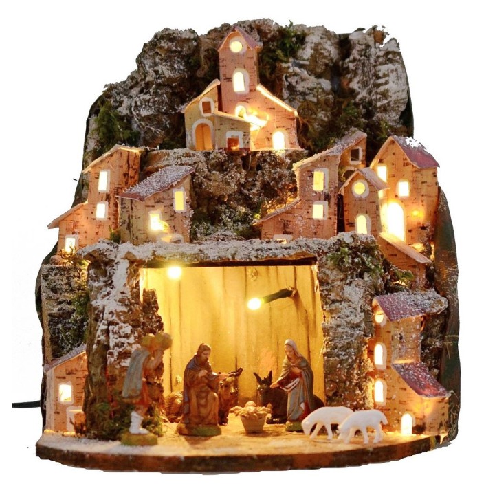 Snow-covered illuminated nativity scene complete with Landi statues