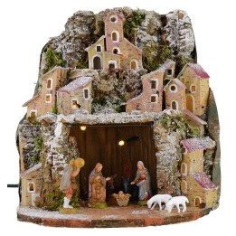 Snow-covered illuminated nativity scene complete with Landi statues