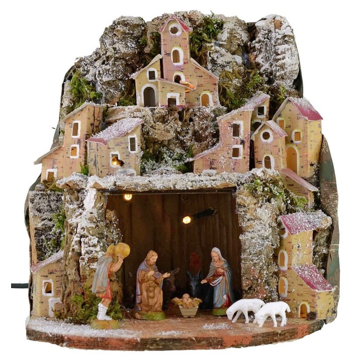 Snow-covered illuminated nativity scene complete with Landi statues