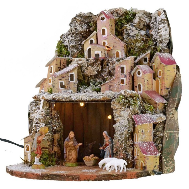 Snow-covered illuminated nativity scene complete with Landi statues