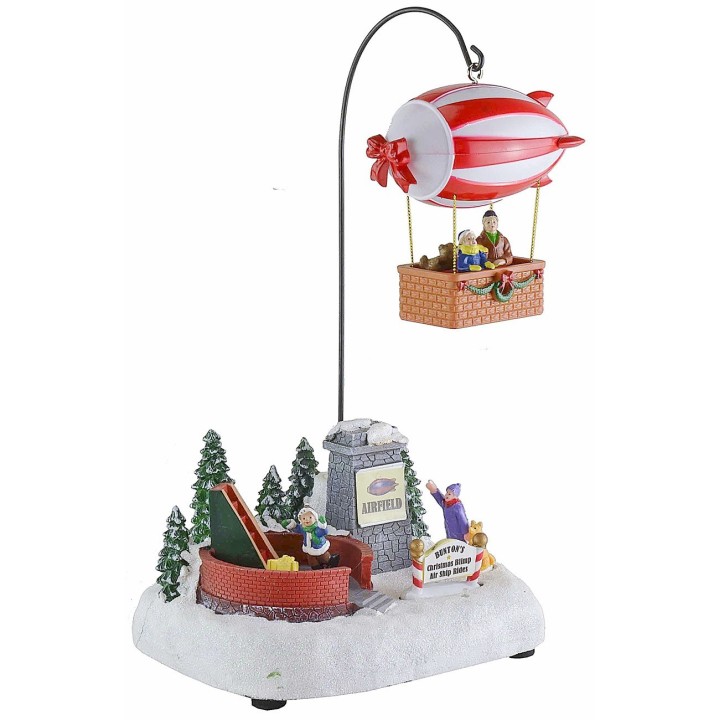Escenario navideño con dirigible a pilas completo de música e