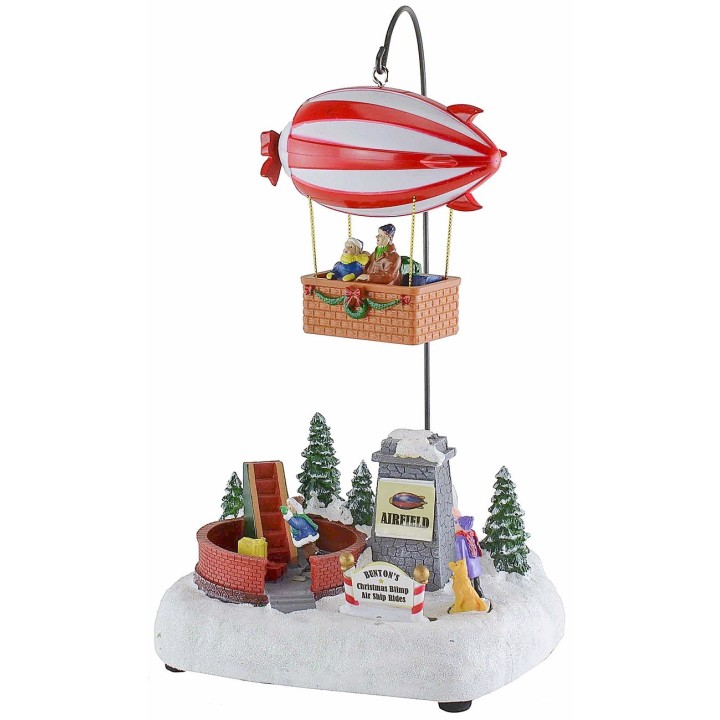 Escenario navideño con dirigible a pilas completo de música e