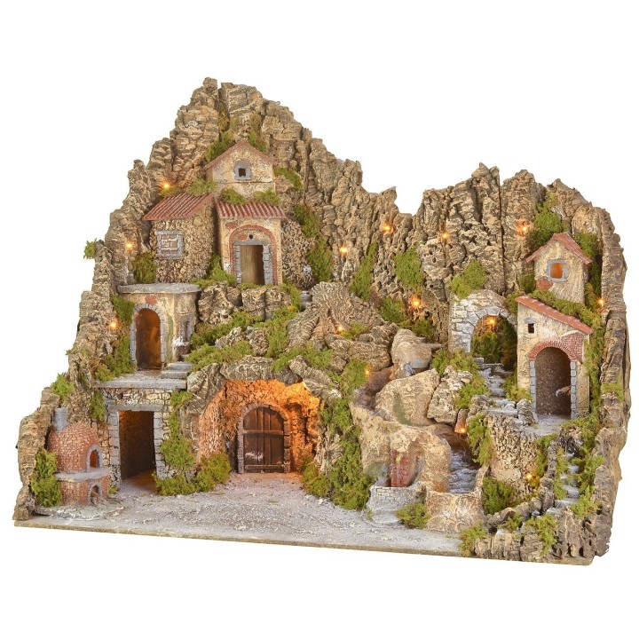 Illuminated nativity scene with cave, fountain, waterfall and fire