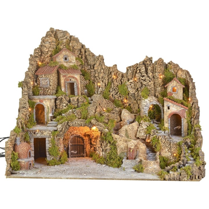 Illuminated nativity scene with cave, fountain, waterfall and fire
