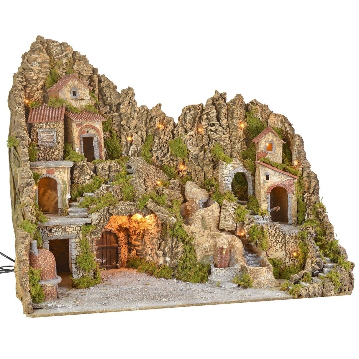 Illuminated nativity scene with cave, fountain, waterfall and fire
