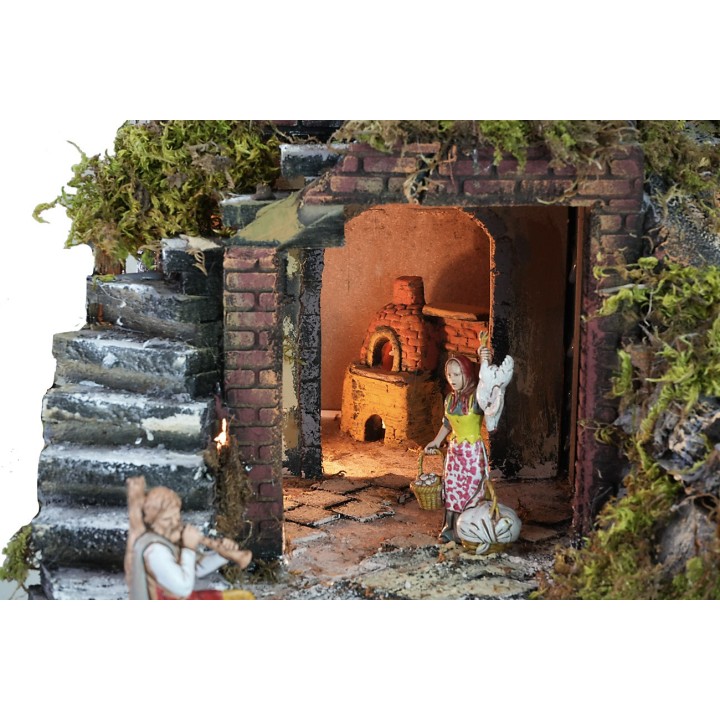 Illuminated nativity scene complete with statues with waterfall, fountain and