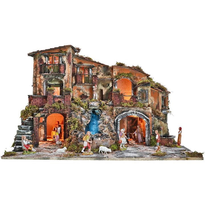 Illuminated nativity scene complete with statues with waterfall, fountain and