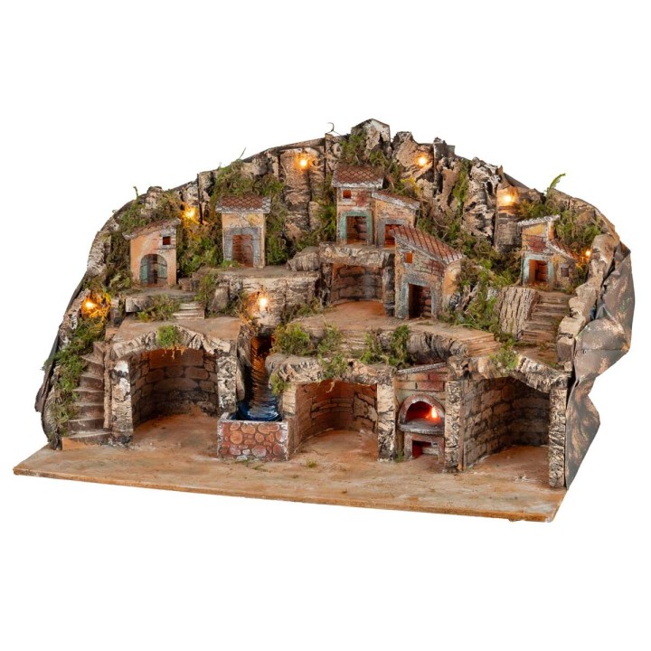 Belén iluminado con cuevas, casitas, arroyo y horno