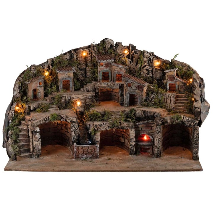 Belén iluminado con cuevas, casitas, arroyo y horno