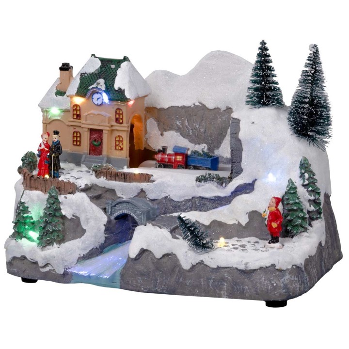 Pueblo navideño con tren en movimiento equipado con luces y
