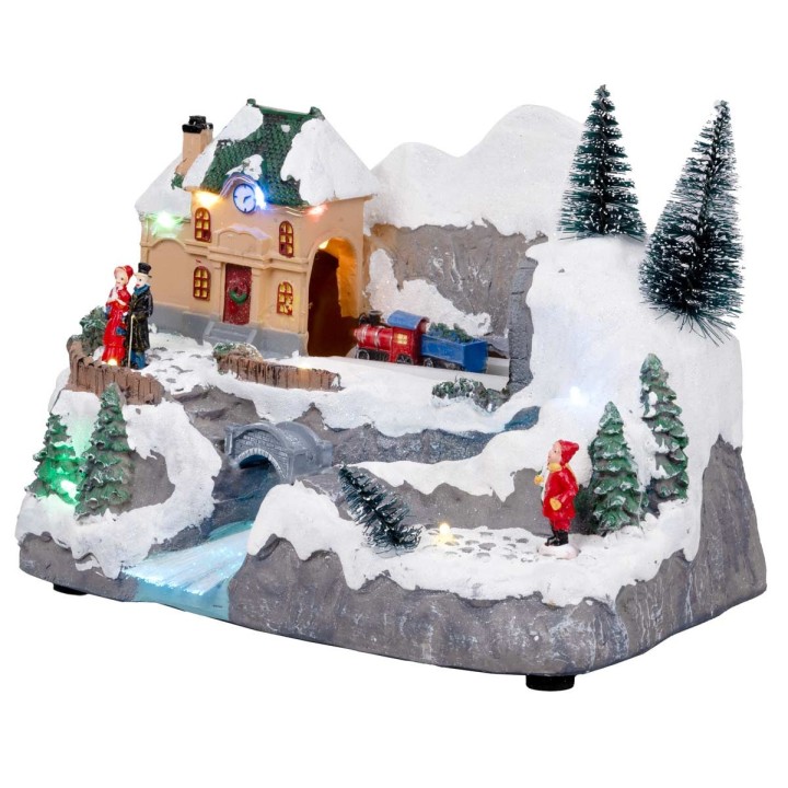 Pueblo navideño con tren en movimiento equipado con luces y