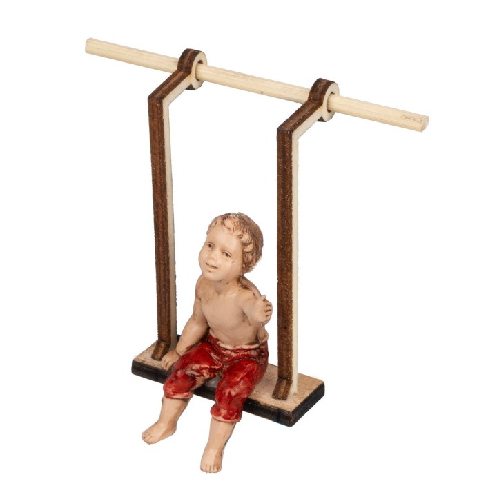 Bambino su altalena in legno serie 10 cm
