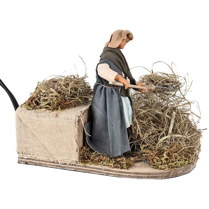 Peasant woman spreading straw in motion 12 cm