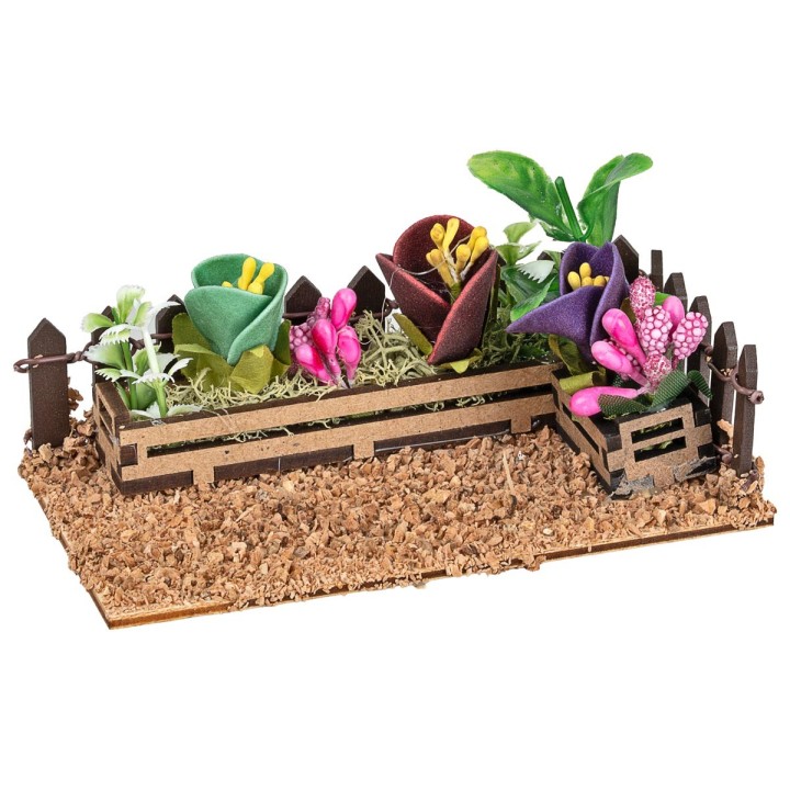 Fenced small garden with assorted flowers and plants cm