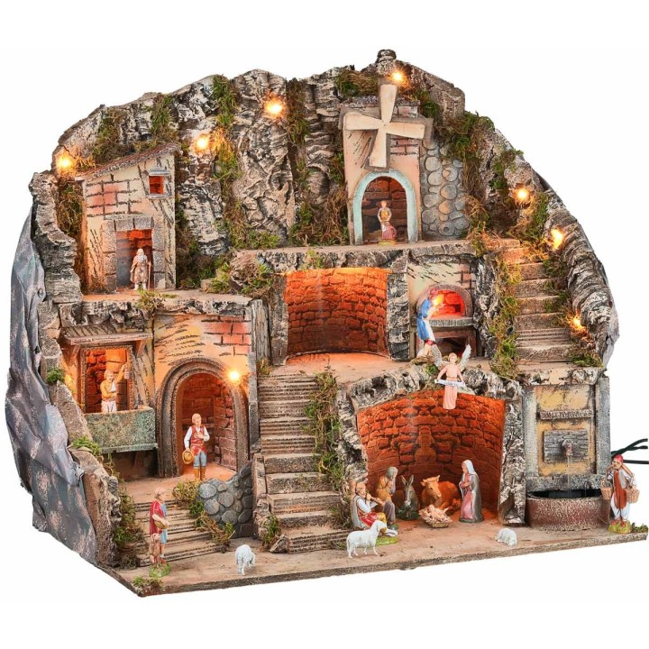 Presepe illuminato con statue, fontana, fuoco e mulino a vento