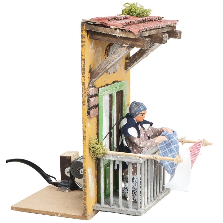 Woman on the balcony hanging clothes 10 cm in motion