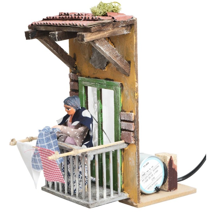 Woman on the balcony hanging clothes 10 cm in motion