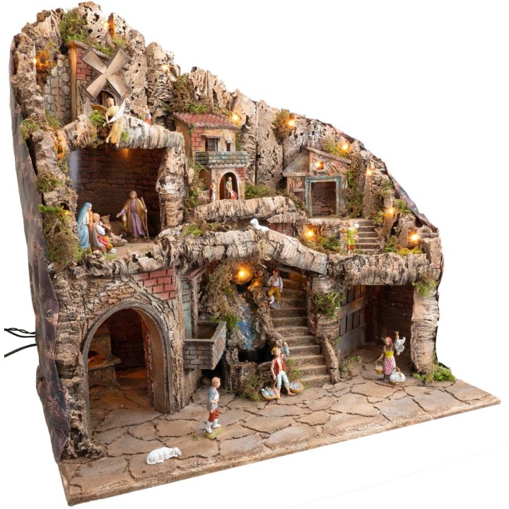 Illuminated nativity scene with statues, stream, oven, and windmill