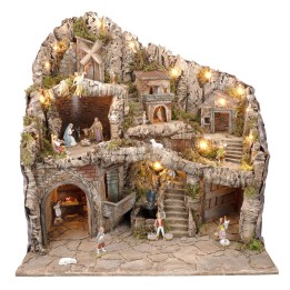 Illuminated nativity scene with statues, stream, oven and