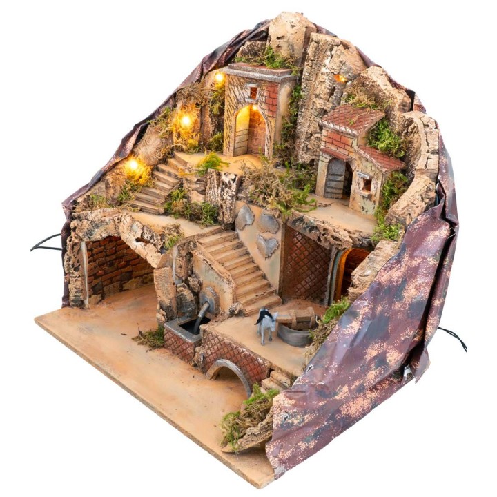 Illuminated nativity scene with fountain and
