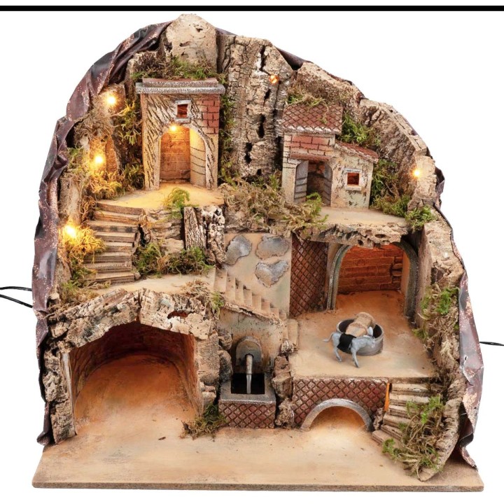 Illuminated nativity scene with fountain and