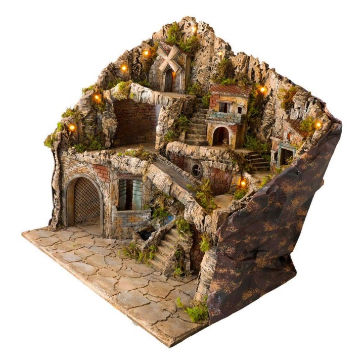 Illuminated nativity scene with statues, stream