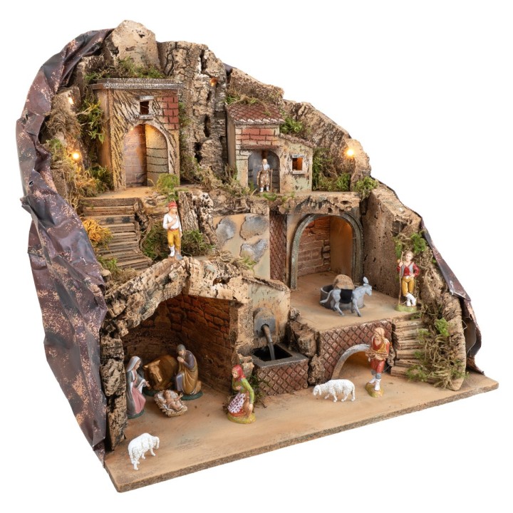 Illuminated nativity scene with fountain and